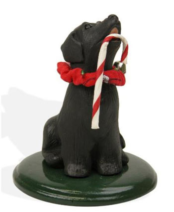 black lab with candy cane figurine